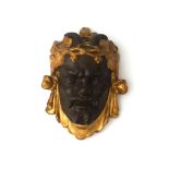 Art Nouveau A figurative wall ornament shaped as a Faun's head with gilt grapevines, circa 1900-
