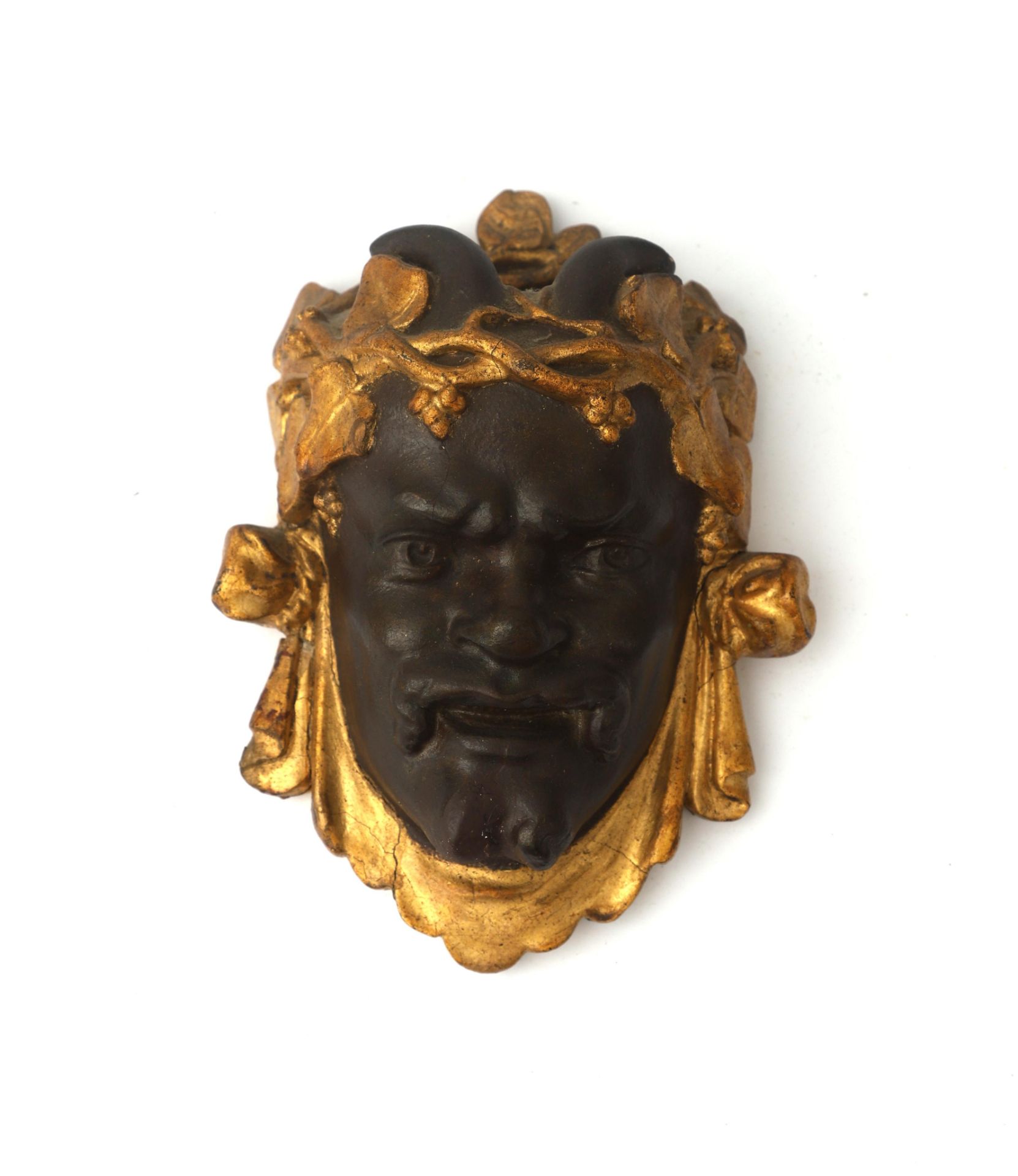 Art Nouveau A figurative wall ornament shaped as a Faun's head with gilt grapevines, circa 1900-