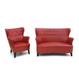 Midcentury Modern A red leatherette upholstered two-seater sofa and an easy chair, the wooden feet