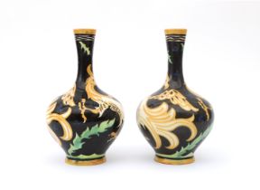 Carel Adolph Lion Cachet (1864-1945) A pair of ceramic vases decorated with griffons in orange on