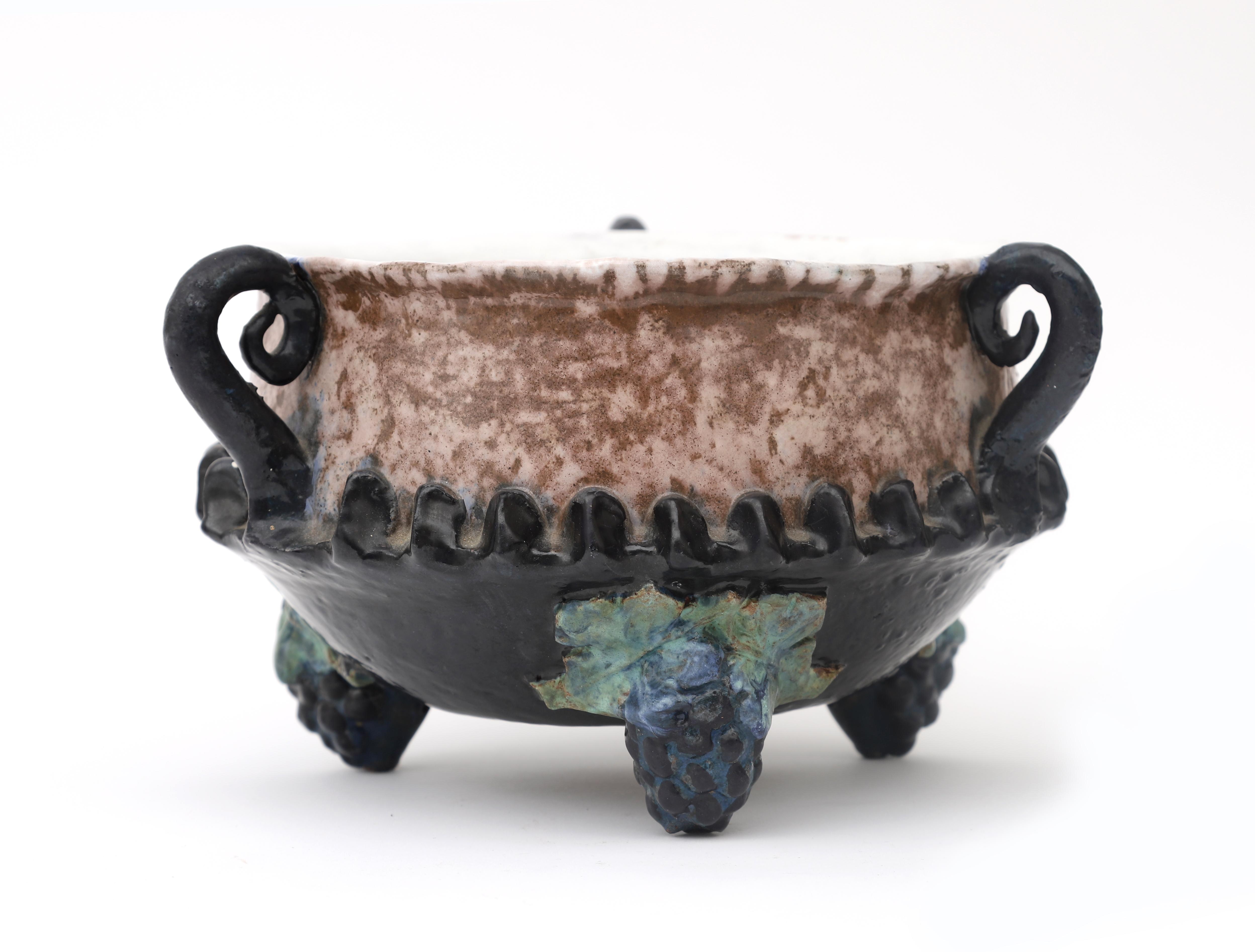 Hildo Krop (1884-1970) A ceramic 'Druivenschaal' (grape dish) with three handles, on three feet