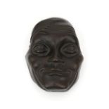 Amsterdamse School A patinated bronze wall sculpture shaped as a mask, circa 1930, struck with