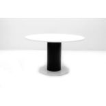 Eighties A circular dining table, white Carrara marble top on cylindrical black lacquered metal on