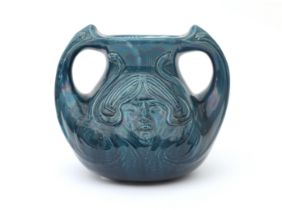 De Distel, Amsterdam A blue glazed ceramic two-handled vase, decorated with female head in relief,