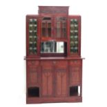 Art Nouveau A mahogany sideboard, the upper part with four glass-paned doors and a mirror, the lower