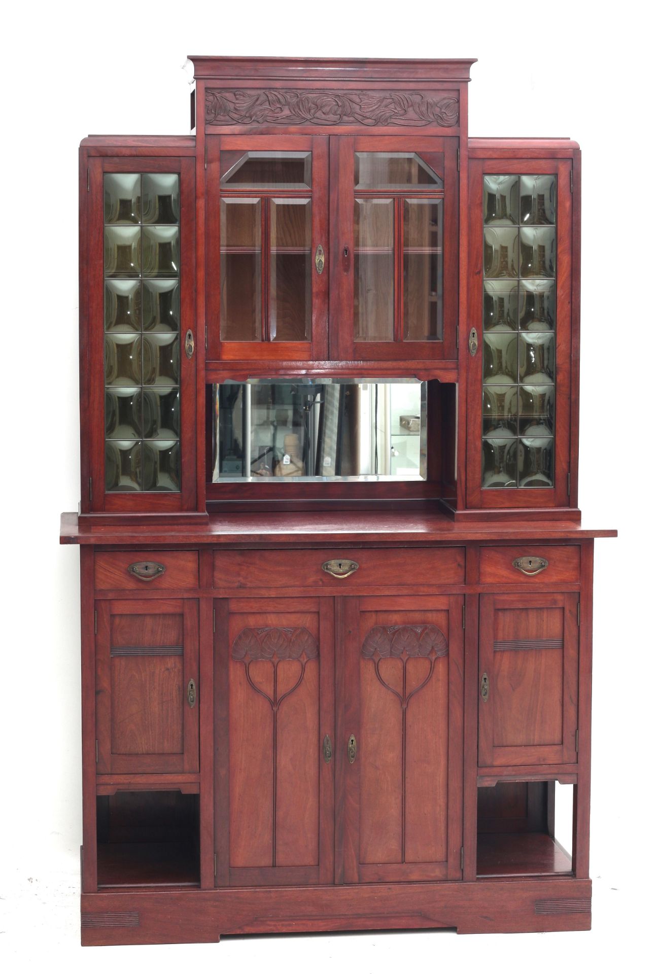 Art Nouveau A mahogany sideboard, the upper part with four glass-paned doors and a mirror, the lower