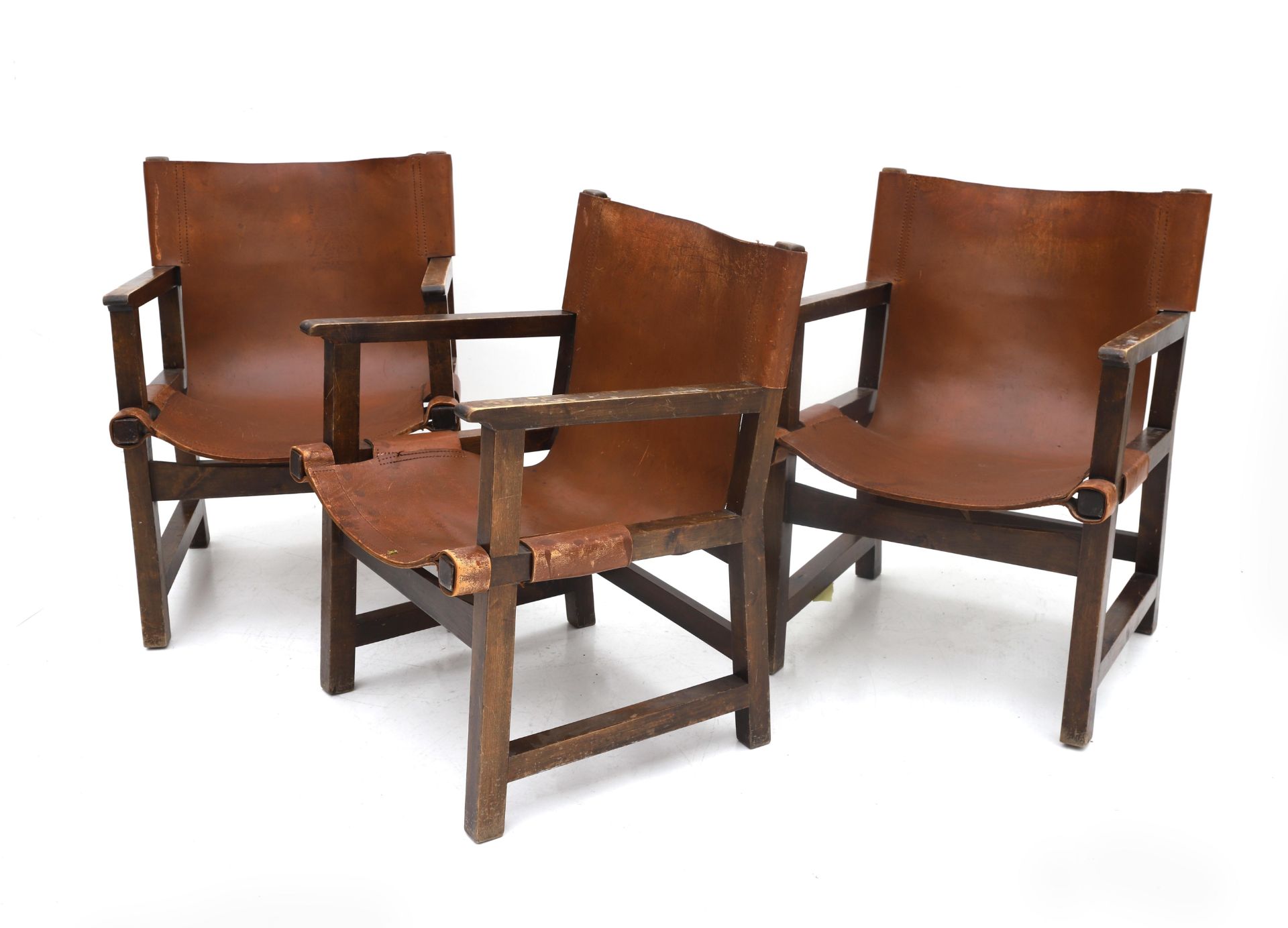 Paco Muñoz (1929-2009) Three Spanish lacquered wooden armchairs with brown saddle leather seats,