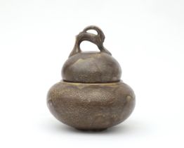 Hildo Krop (1884-1970) A grey/brown glazed ceramic lidded jar, the grip of the handle shaped as an