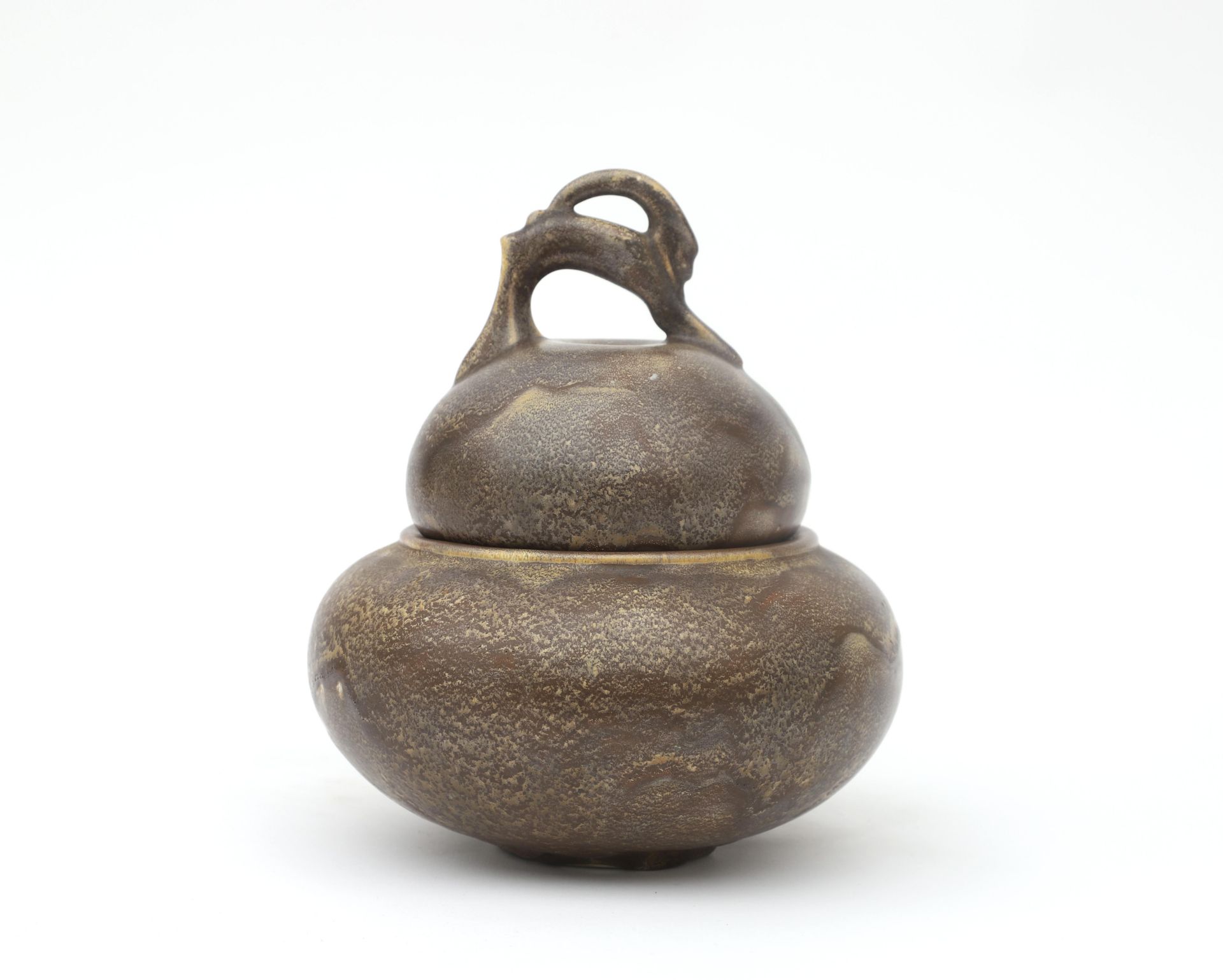 Hildo Krop (1884-1970) A grey/brown glazed ceramic lidded jar, the grip of the handle shaped as an