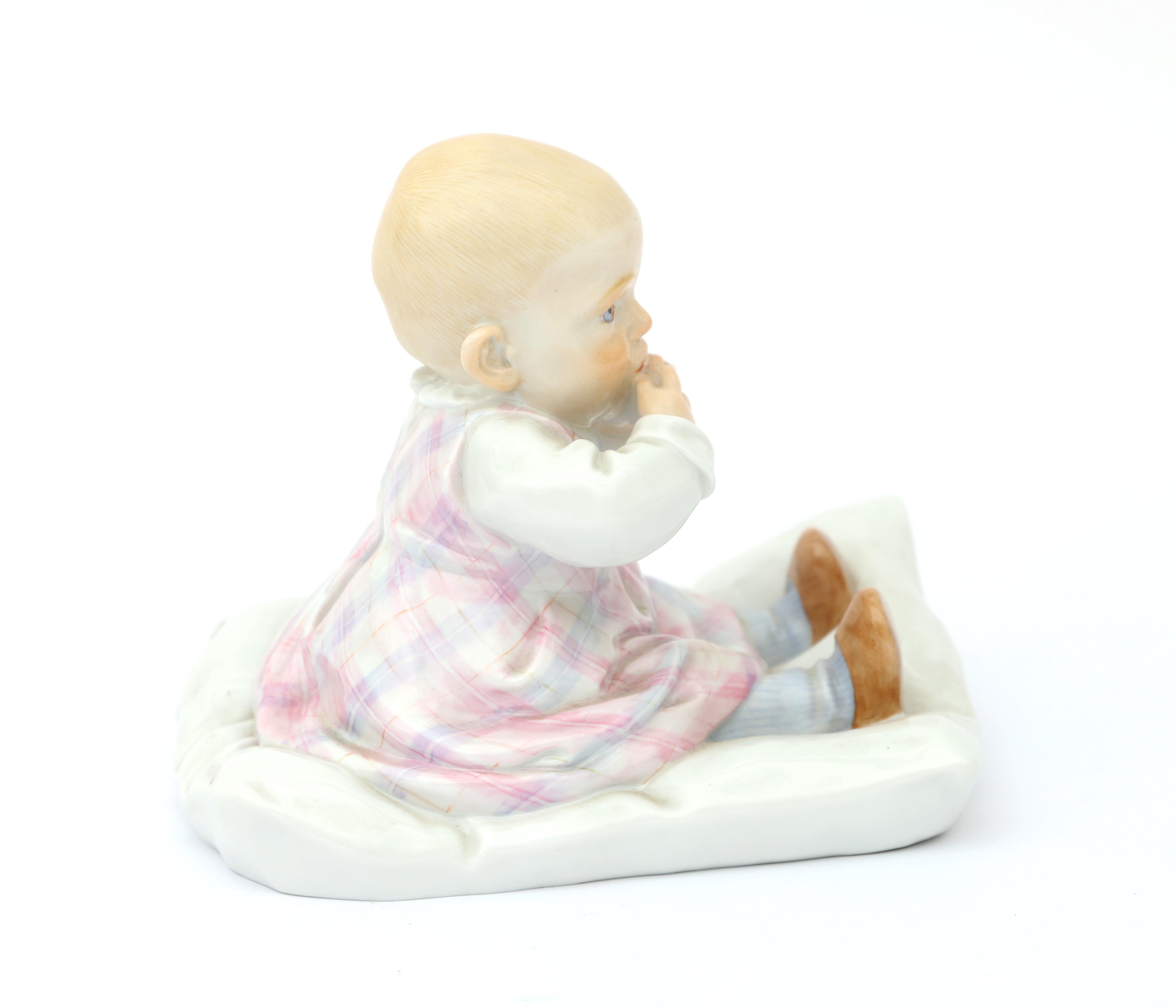 Konrad Hentschel (1872-1907) A porcelain figure of a child sitting on a cushion, produced by - Image 3 of 4