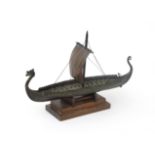 Edw. Aagaard, Denmark A bronze replica of a Viking ship, on wooden stand, marked and with date: '