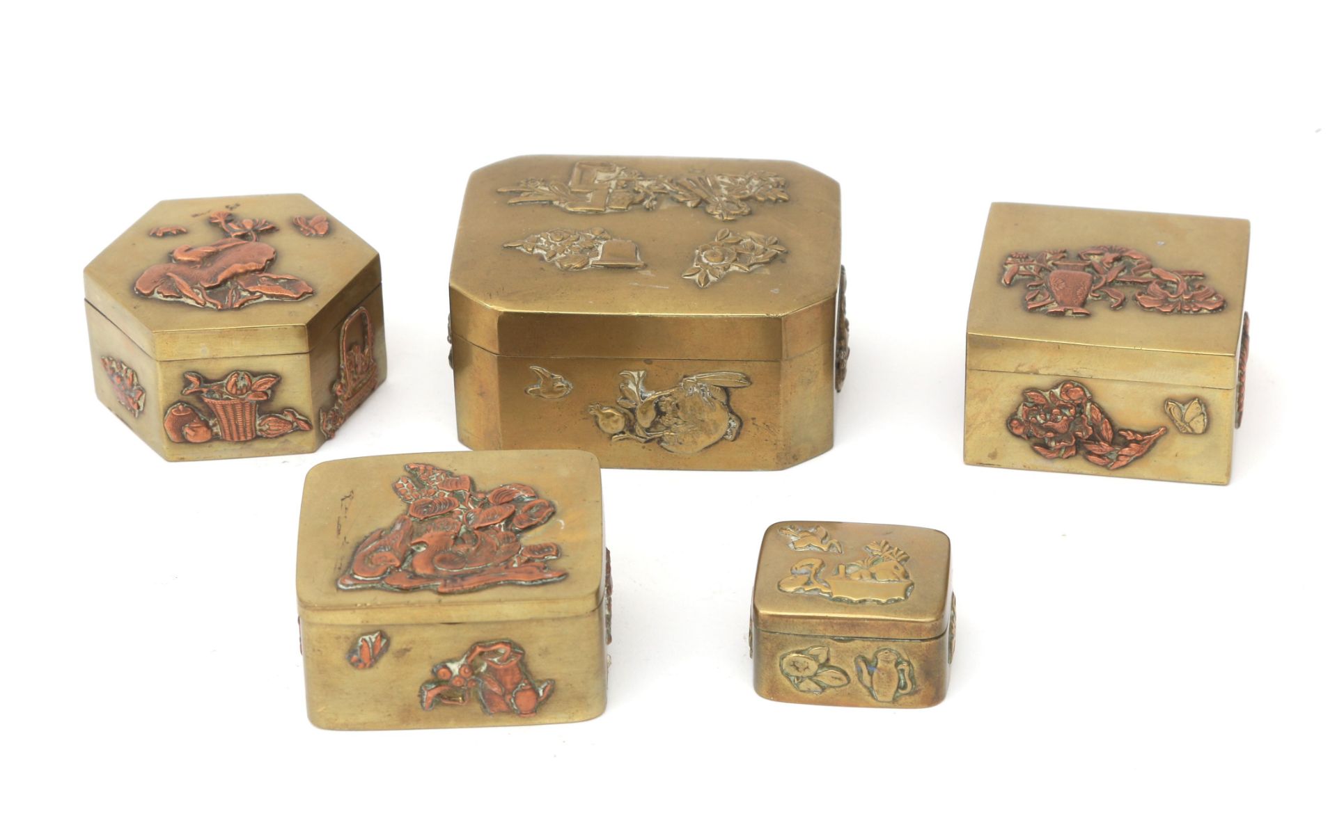 Five Japanese brass boxes with copper relief decoration of birds, flowers, etc., first quarter 20th