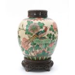 A polychrome Chinese porcelain ginger jar, decorated with a bird-of-paradise, flowers and plants,