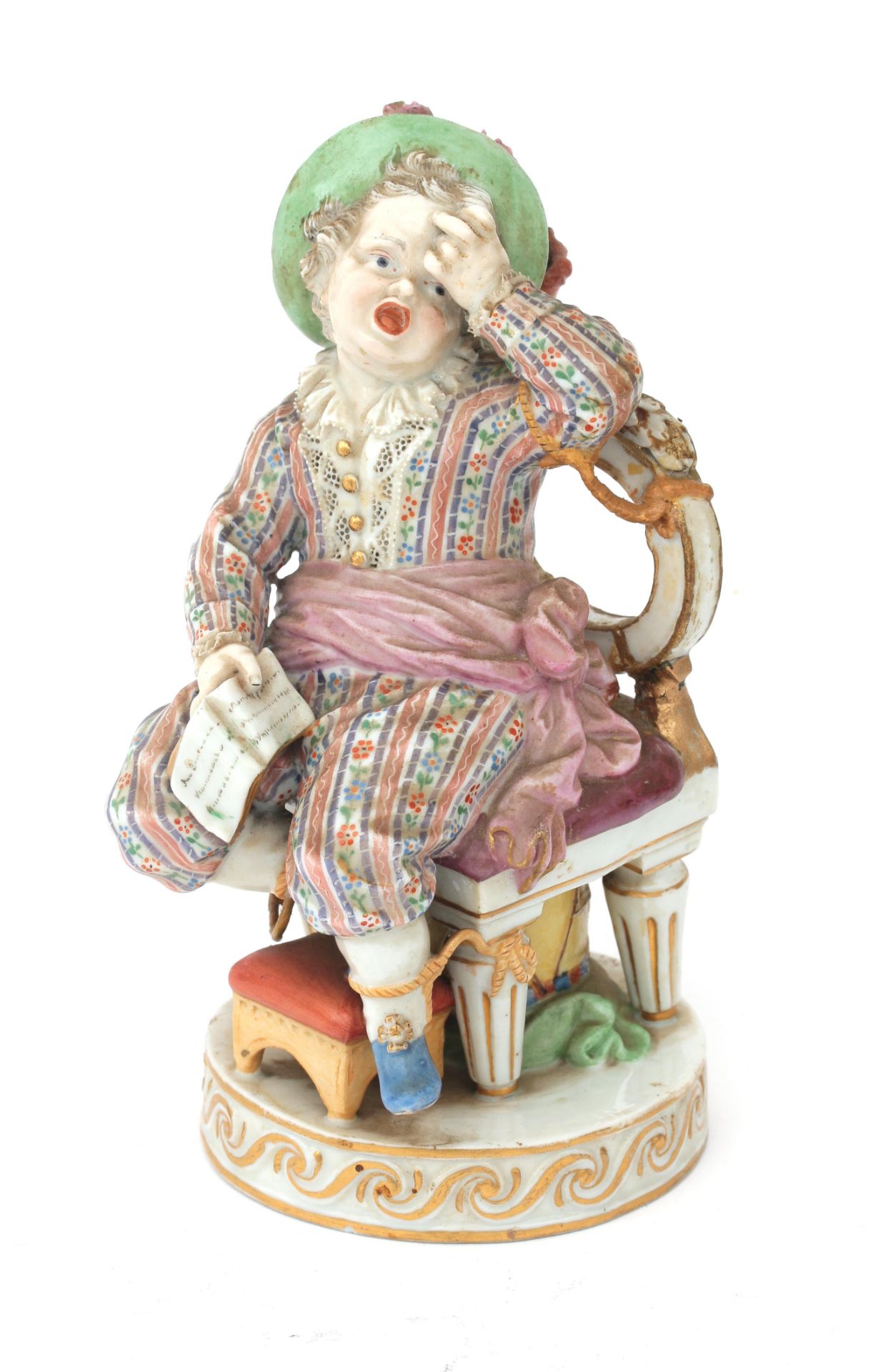 A polychrome porcelain Meissen figurine of a naughty boy who is tied to his chair in order to get