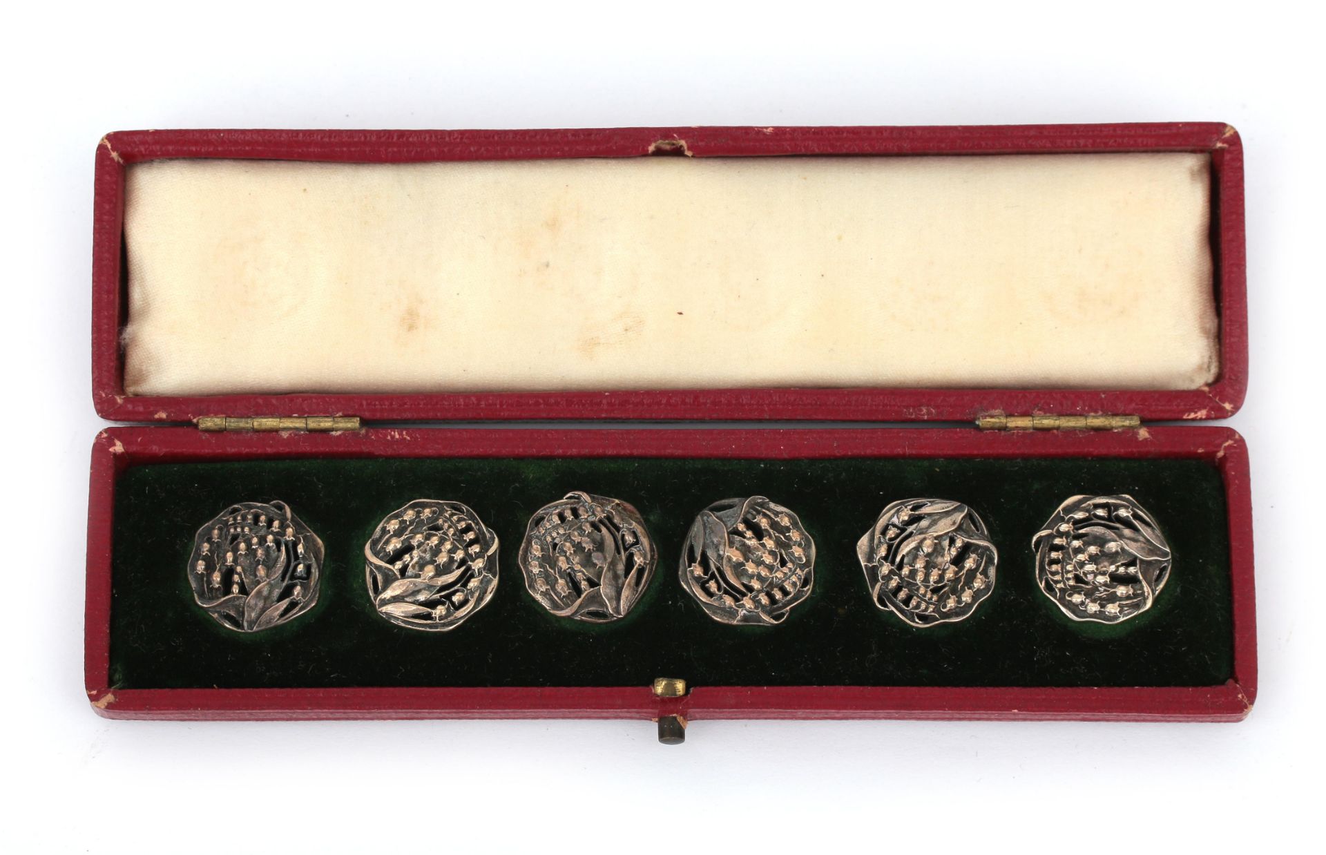 Six pierced silver modern style lily of the valley buttons in case, reg. nr. 394736, circa 1900.