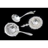A pair of 2nd grade silver tea strainers and a silver cream spoon. First half of the 20th century.