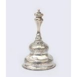 A Dutch silver table bell, clock-shaped bell with clapper, baluster-shaped fluted handle. Copper