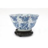 An octagonal Chinese porcelain bowl on round base with blue-and-white blossom decoration, marked