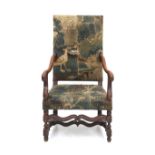 A nutwooden William & Mary armchair, Dutch, early 18th century. Upholstered with fragments of a
