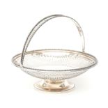 A round pierced 835 silver swing handle basket with beaded borders on base, maker's mark: J.M. van