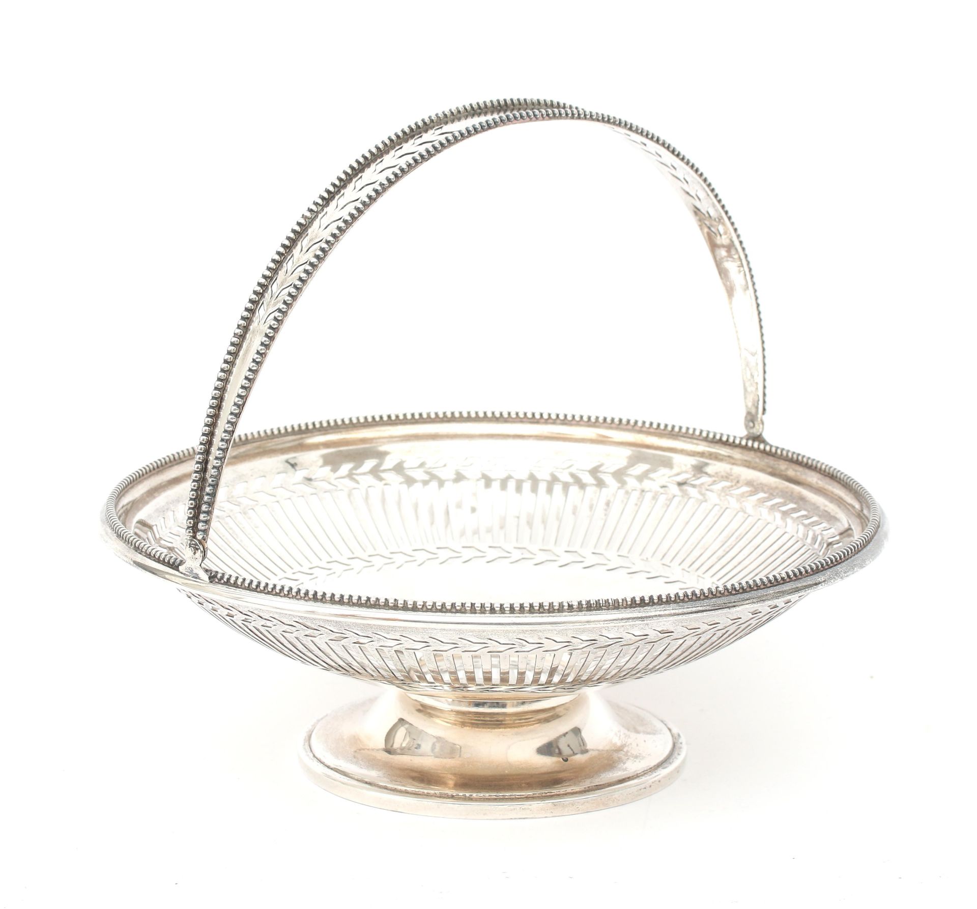 A round pierced 835 silver swing handle basket with beaded borders on base, maker's mark: J.M. van