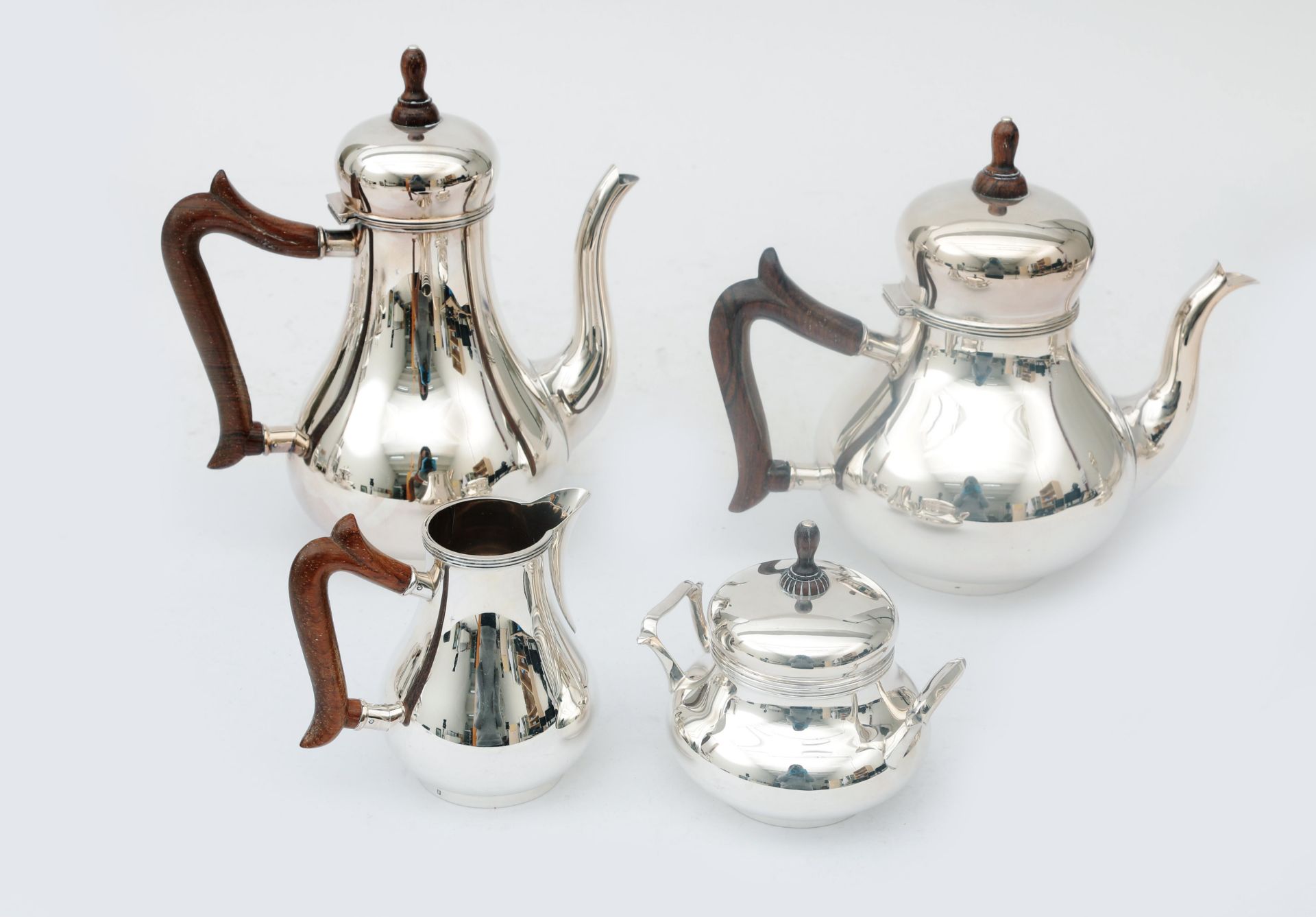 A four-piece sterling silver tea and coffee set, consisting of: a coffee pot, teapot, milk jug and