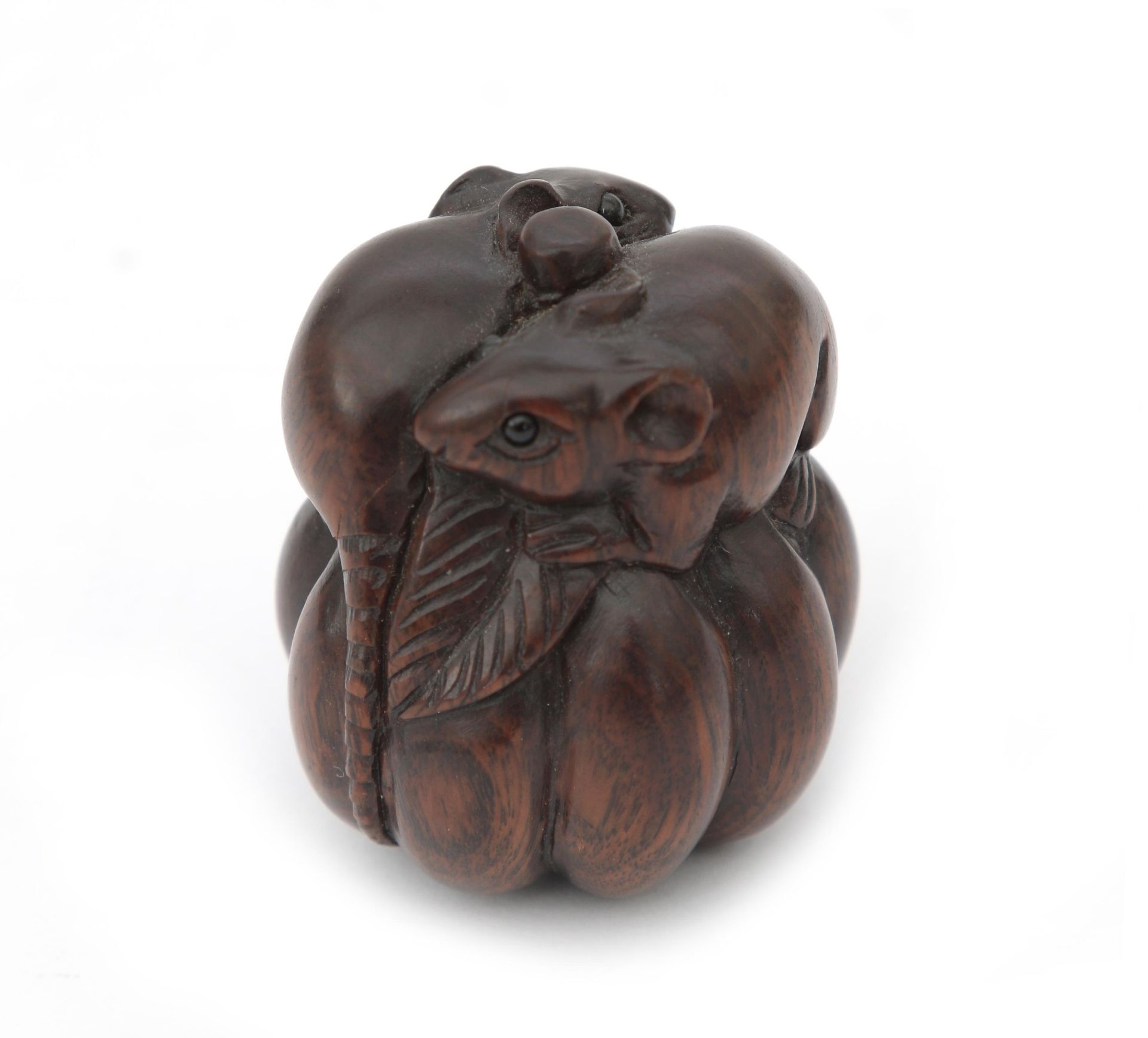 A carved wooden netsuke depicting two rats on a pumpkin, signed. 20th century