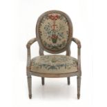 A Louis XVI armchair, France, late 18th century. The woodwork grey painted, the back and seat with