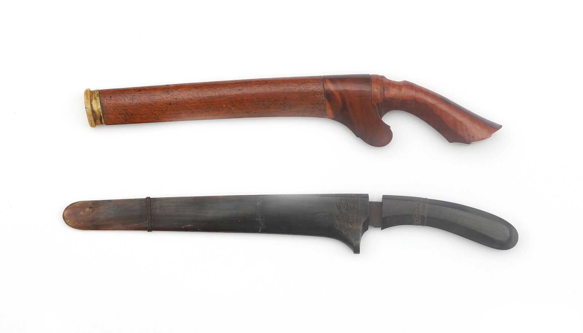 Two Batak knifes in scabbard, Indonesia, 19th century. Of which one with Damascus steel blade, the