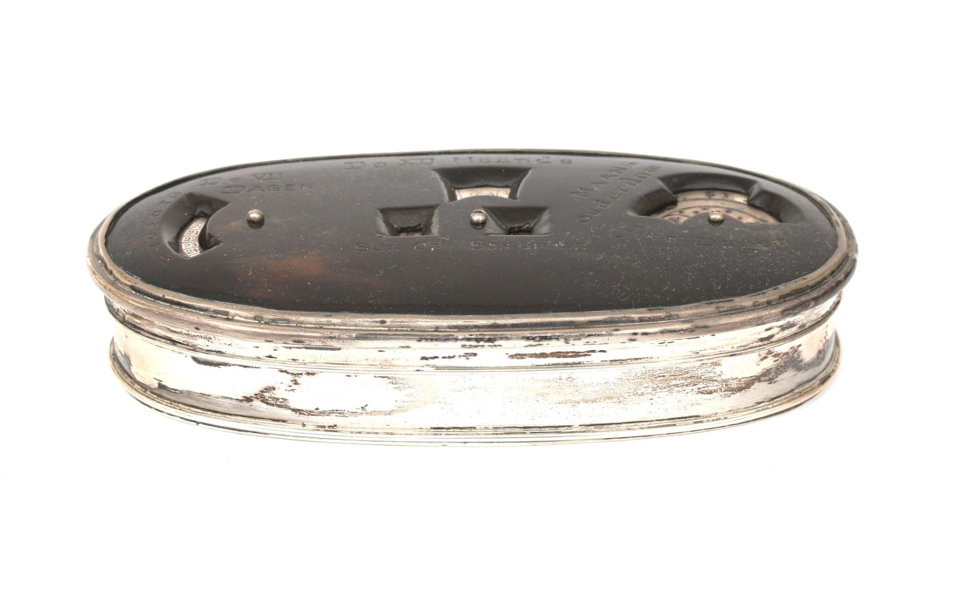 An oval tortoise tabacco box with 835 silver mount and calendar function. The seven days of the week