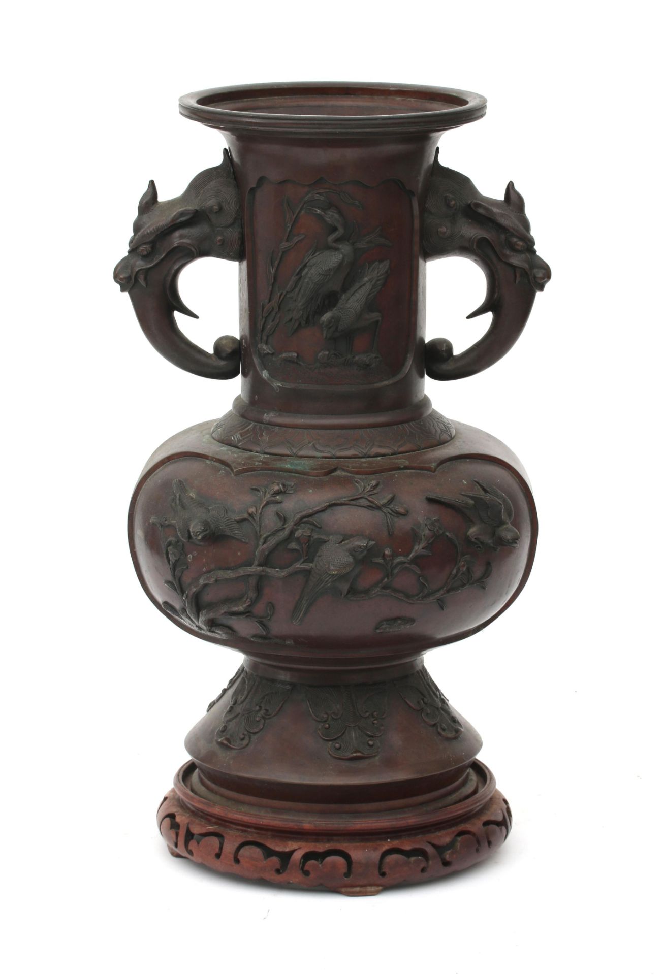 A large Japanese bronze vase with relief decoration of birds, blossoms, bamboo branches and handles
