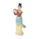A Chinese porcelain figurine of a woman holding a peach, impressed mark, first half 20th century.