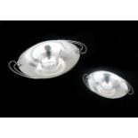 A pair of Dutch silver oval barge-shaped Art Deco dishes with berries, on convex feet. Master marks