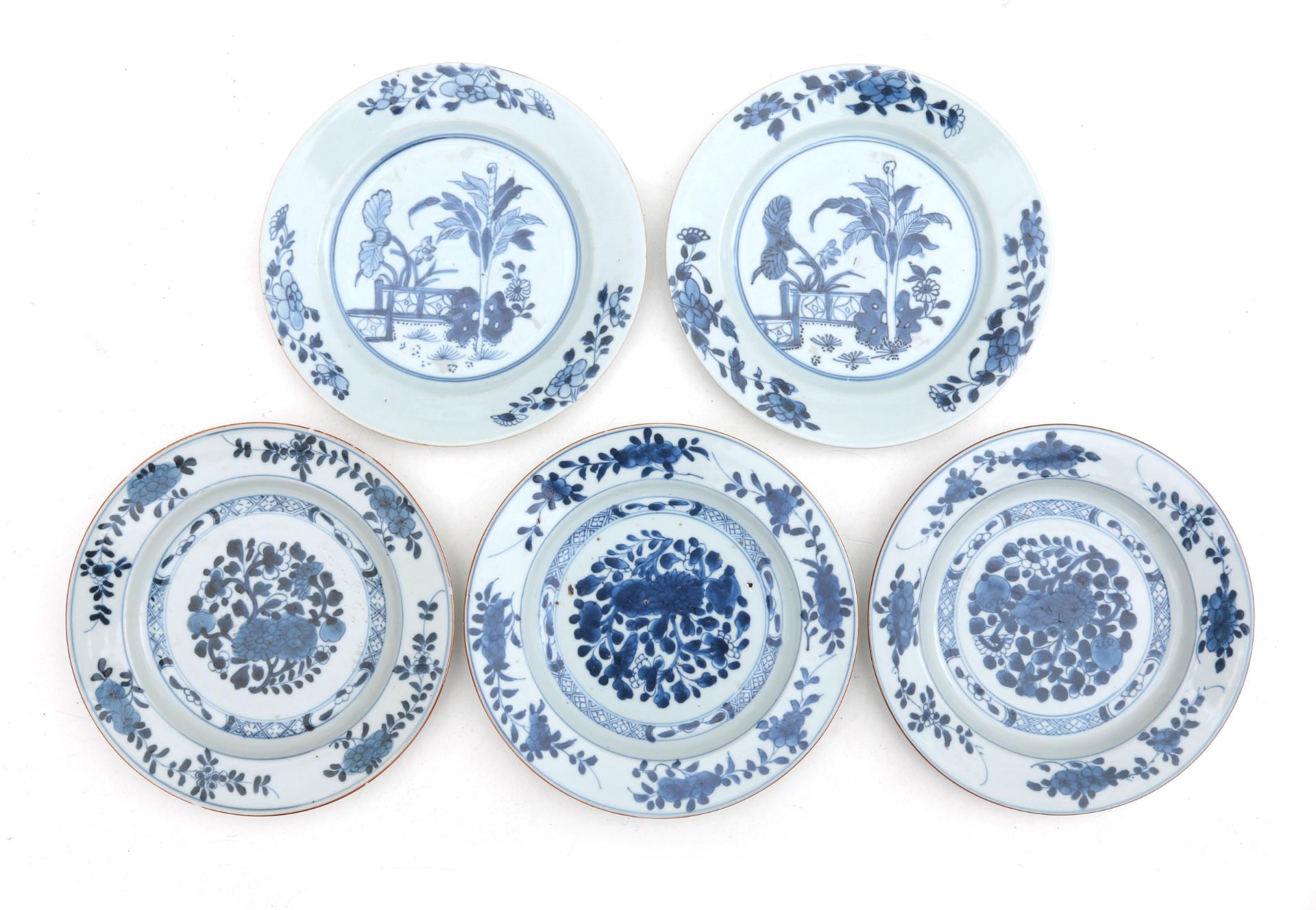 Three Chinese porcelain plates with blue and white foliate decoration, and two plates with tobacco