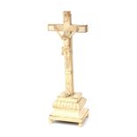 A carved bone crucifix on base decorated with stylized leaf and flower motifs, Louis XVI-stijl,