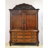An oakwoad Empire cabinet, Dutch, early 19th century. Under an arched tympanum a carved relief with