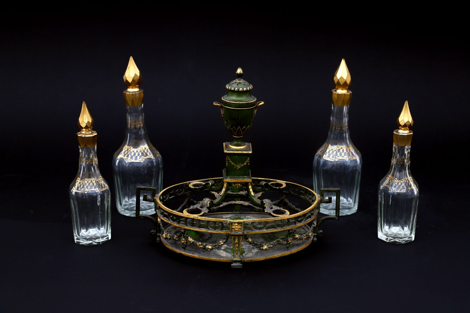 A Louis XVI-style oil and vinegar set, Dutch, 19th century. Four cut glass flasks, cold painted
