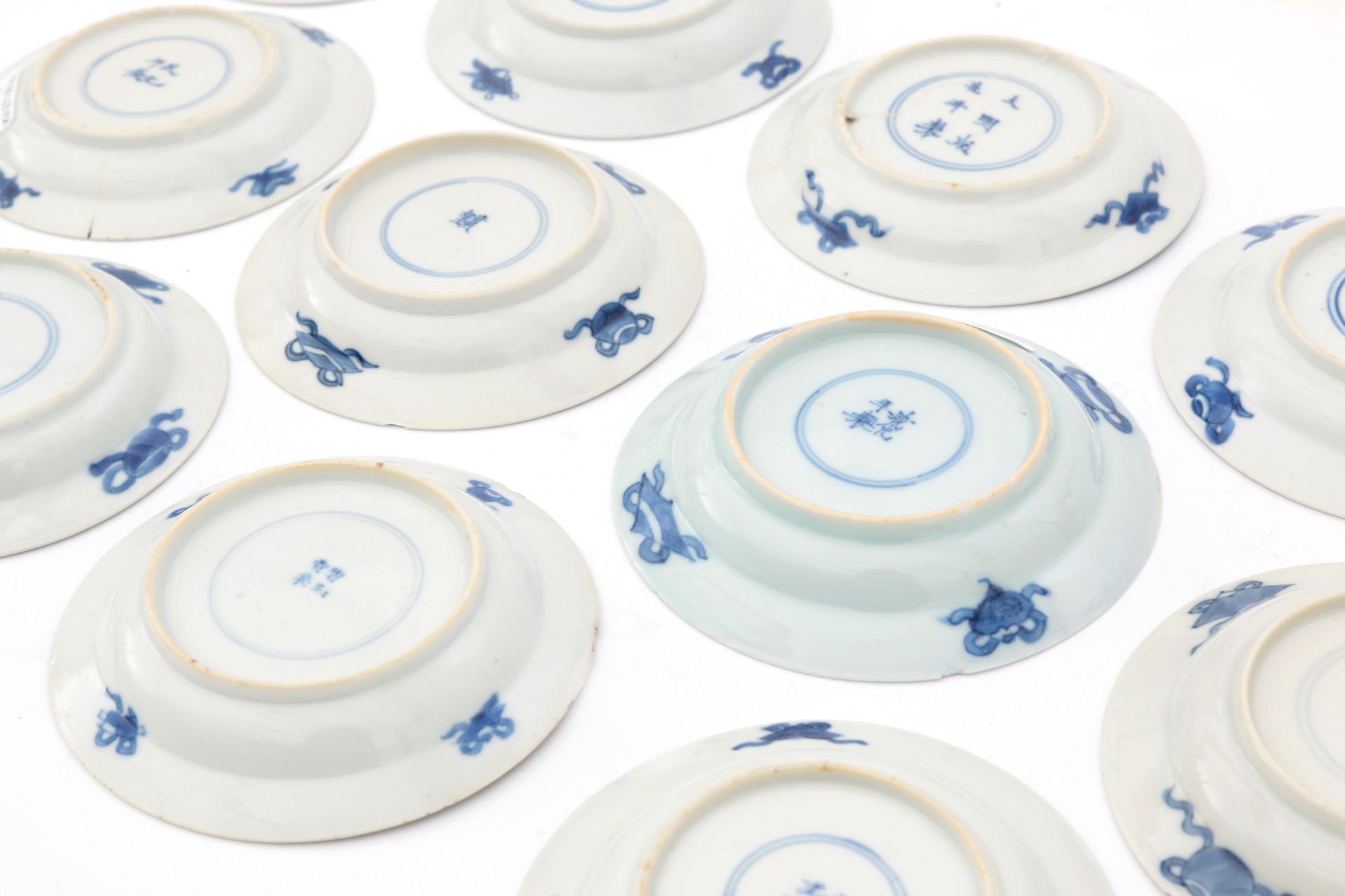 Twelve Chinese porcelain dishes, decorated with a playing child and a woman in a garden in Kangxi- - Image 3 of 4