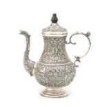 A richly decorated embossed Frisian silver mocha pot with foliate motifs and palisander finial.