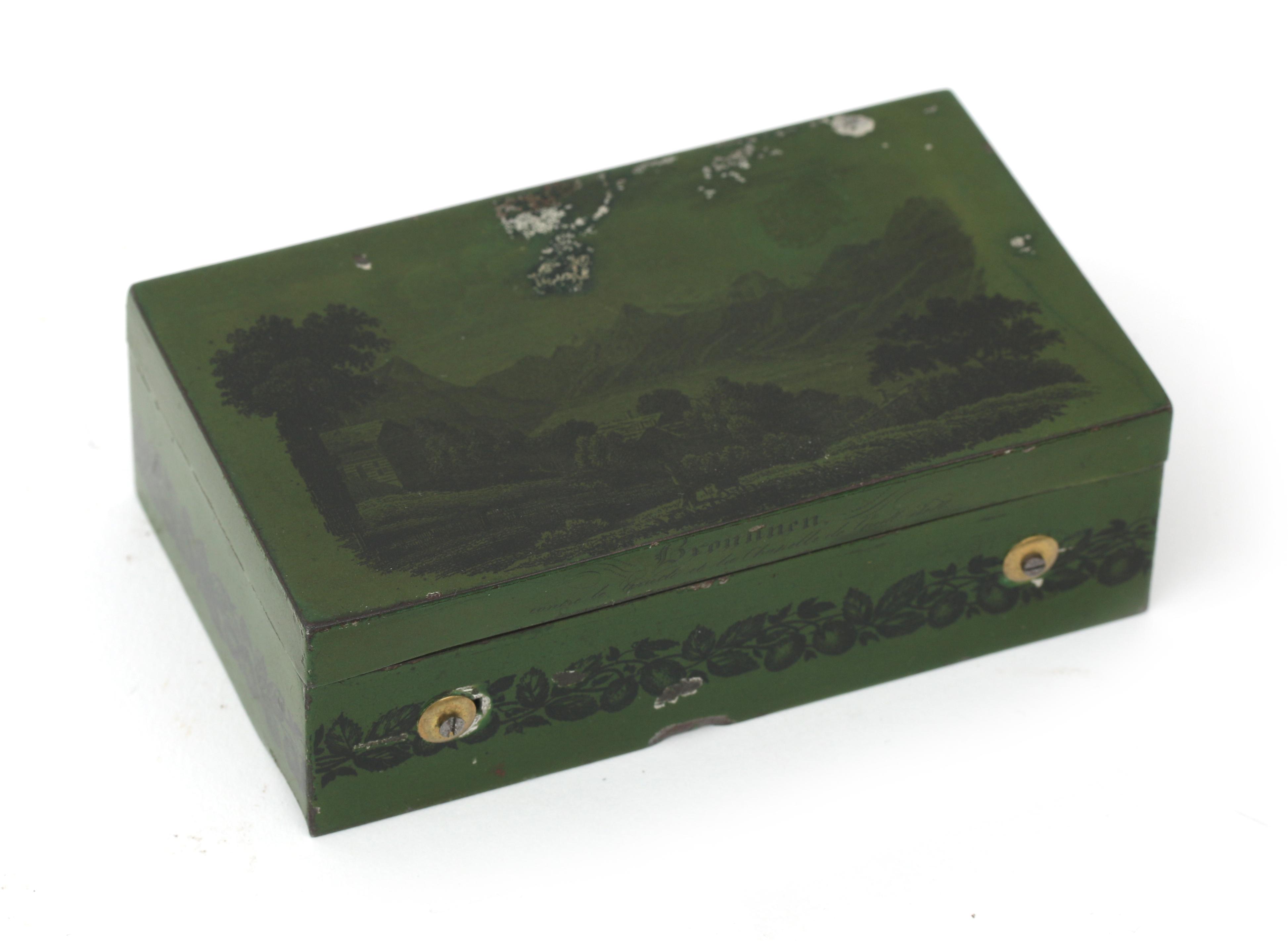 A Swiss souvenir cylinder music box in green tin case decorated with a landscape with the text: - Image 3 of 4