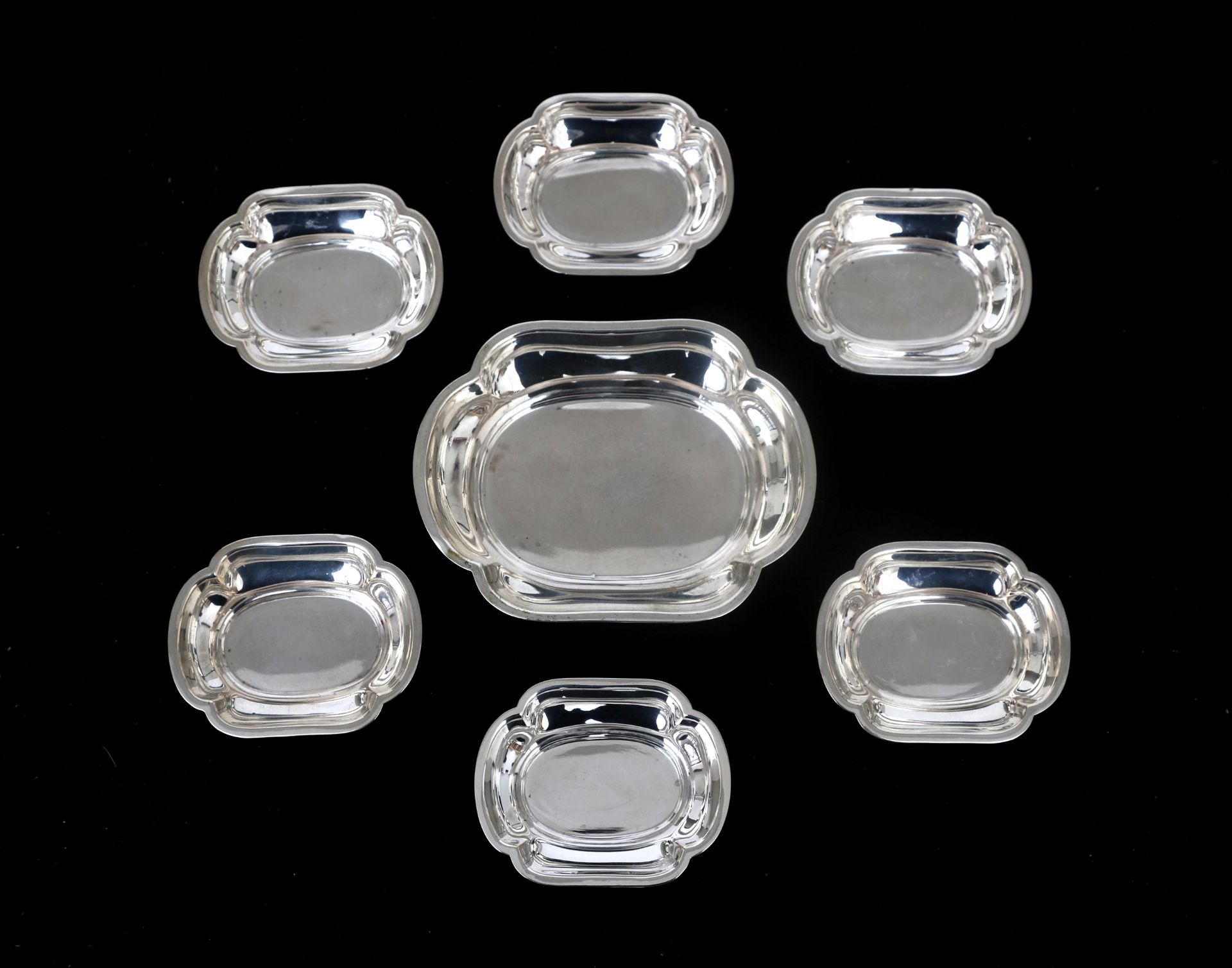 A set of six petit four dishes and serving dish with a contoured deep rim. Marked: Germany, 830S.