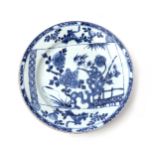 A Chinese porcelain plate with an underglaze blue decoration of a scroll with a painting of a