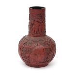 A red Chinese lacquer vase with relief figures in a garden, 20th century H. 41,5 cm.