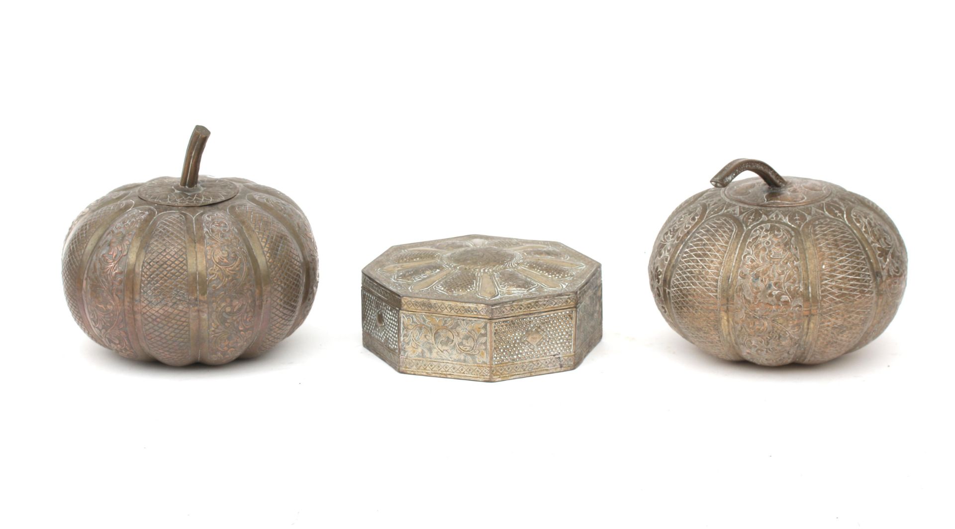 A pair of pumpkin shaped lidded silver boxes and an octagonal lidded box with engraved foliate