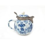 Chinese porcelain teapot, decorated with women and flowers in cartouches, the lid with a shishi