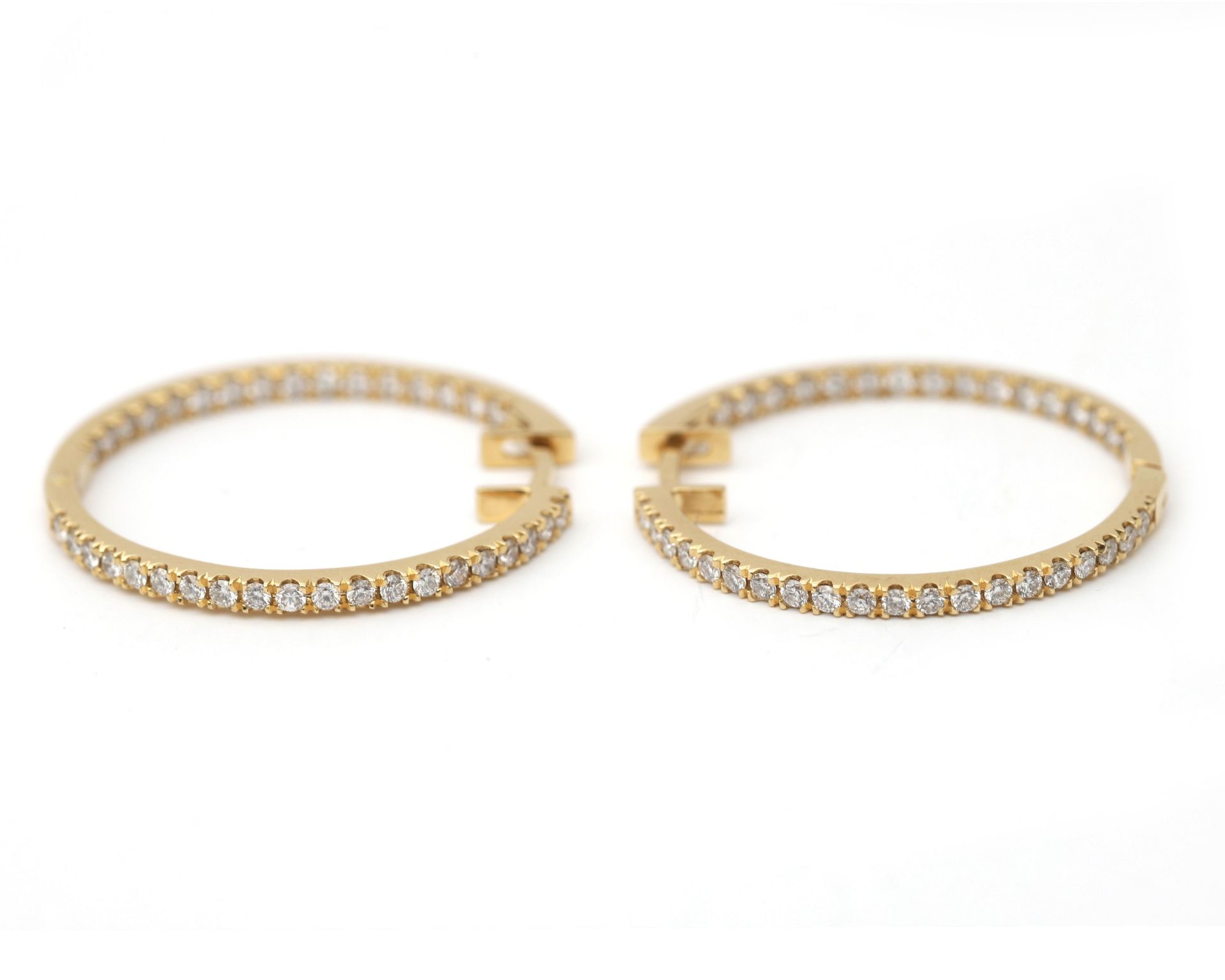 A pair of 18 karat gold earrings, pavé set with brilliant at the in and the outsite - Image 2 of 4