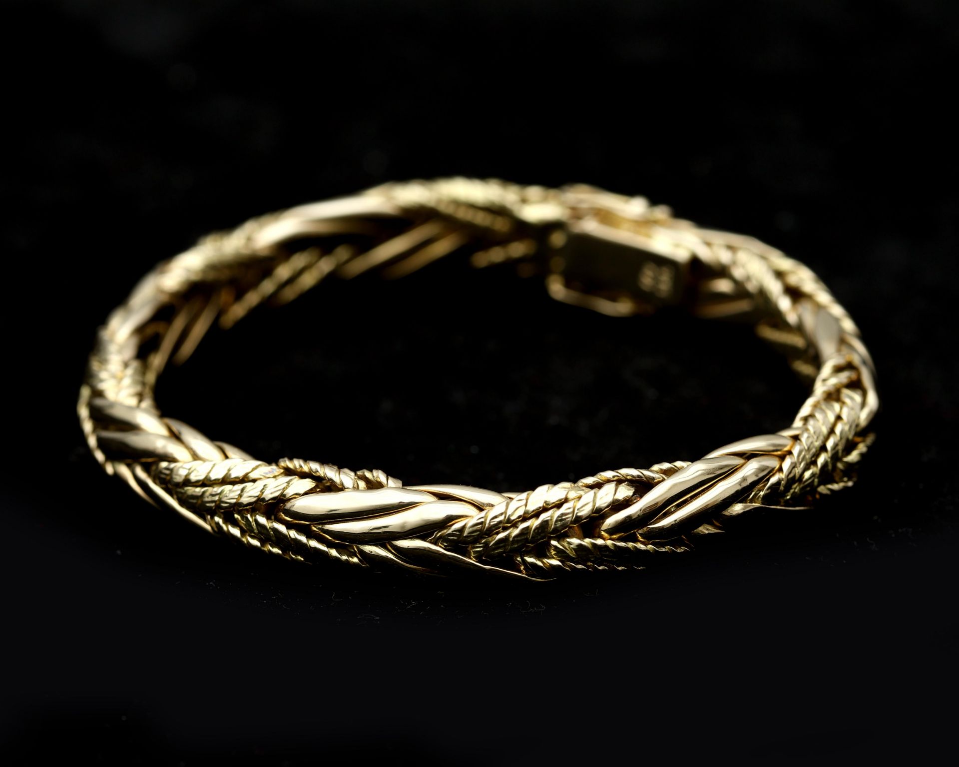 A 14 karat gold braided bracelet 