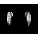 A pair of 18 karat white gold earrings by Piaget, with diamonds