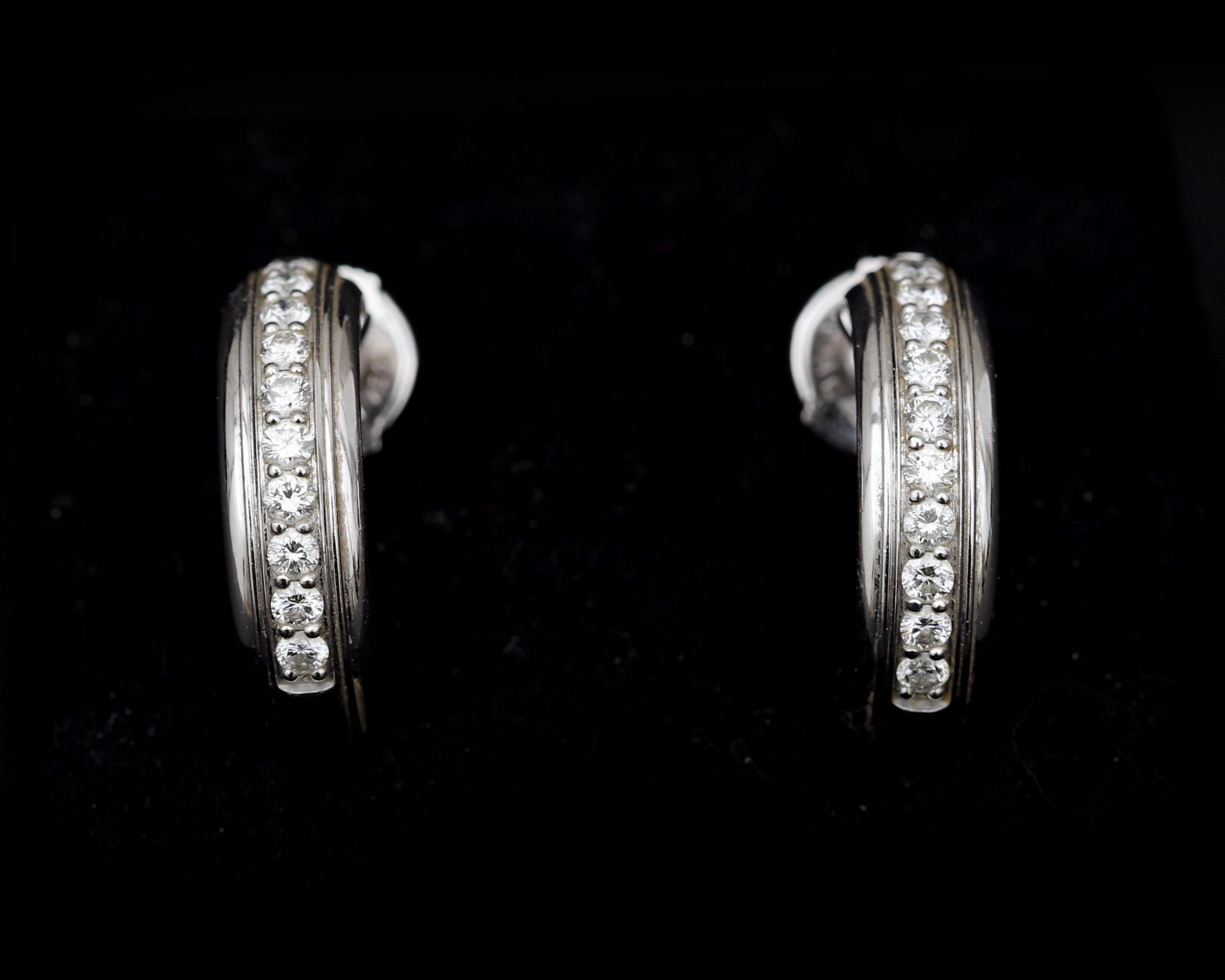 A pair of 18 karat white gold earrings by Piaget, with diamonds 