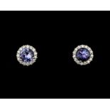 A pair of 18 karat white gold rosette stud earrings, with Tanzanite and diamonds